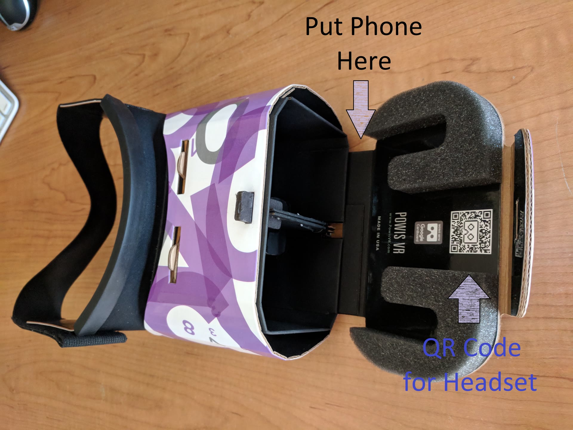 Open VR headset labeled with where to put the phone and the QR code for the headset