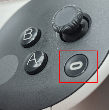 Oculus button on the right-hand Quest controller, outlined in red